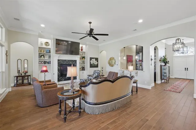 a living room with furniture a fireplace and a flat screen tv
