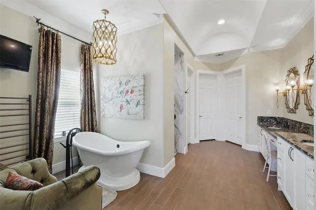 a bathroom with a toilet and a flat screen tv