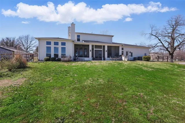 a view of backyard of house and garden