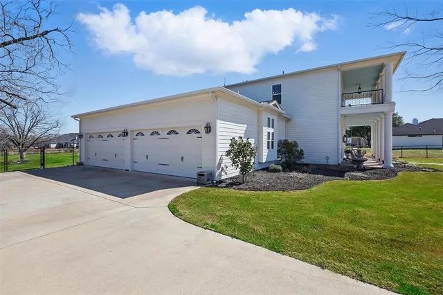 a view of house with garden and basketball court