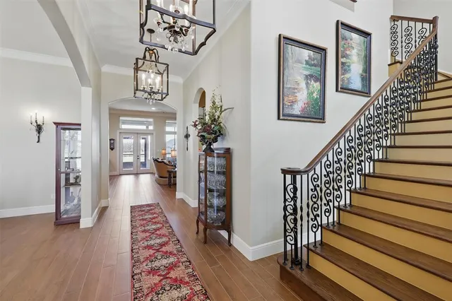 a view of entryway and hall with wooden floor