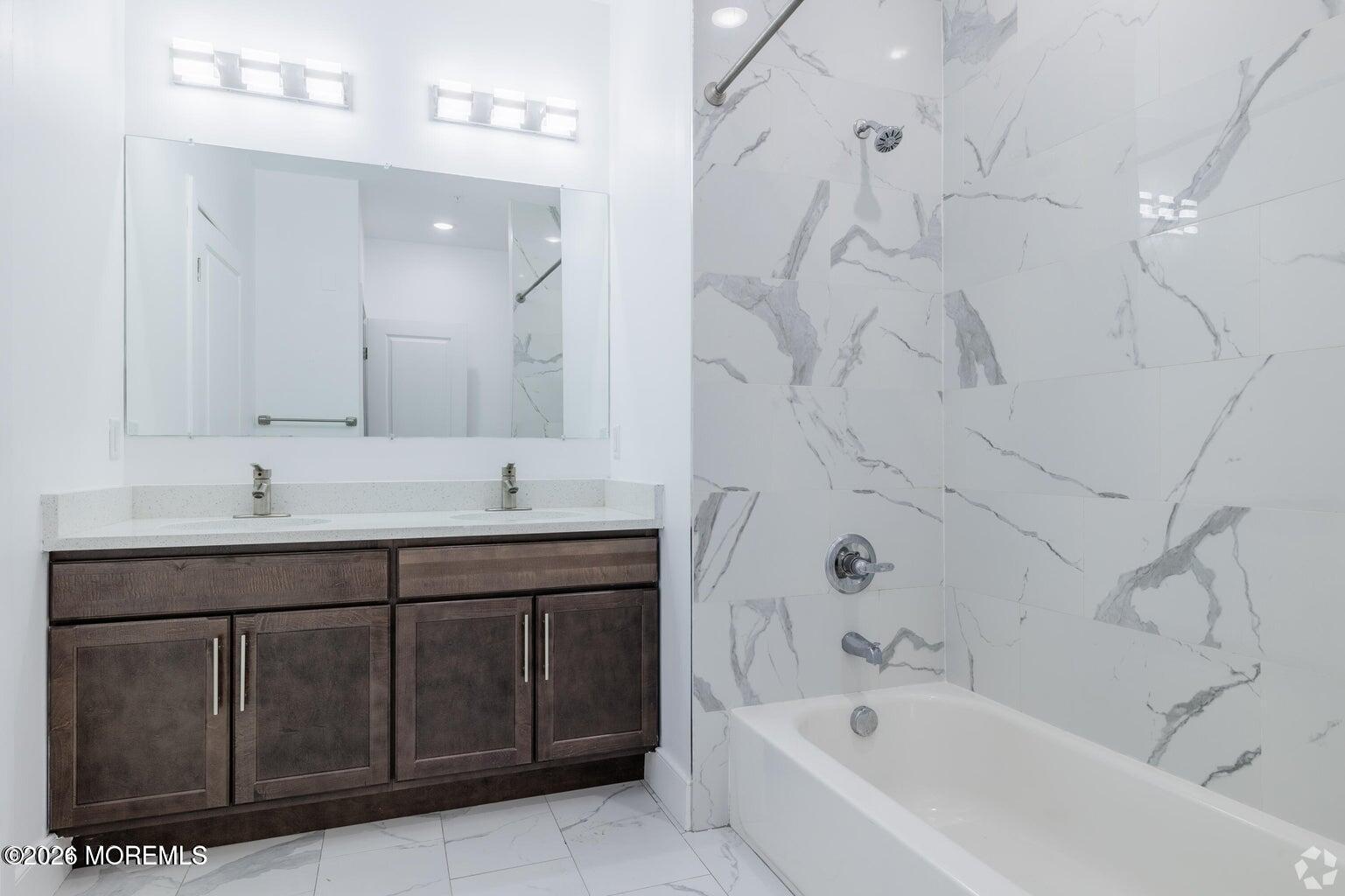 126 Main Street, Unit 311 Matawan, NJ 07747 - Photo 11 of 13 a bathroom with a tub sink and mirror
