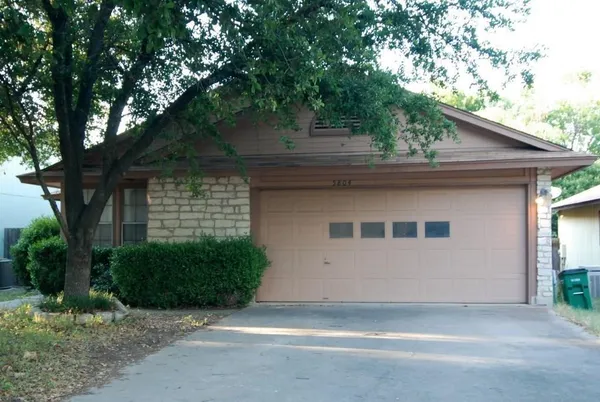 a house that has a tree in front of the house