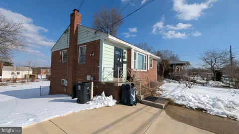 a view of a house with snow on the road