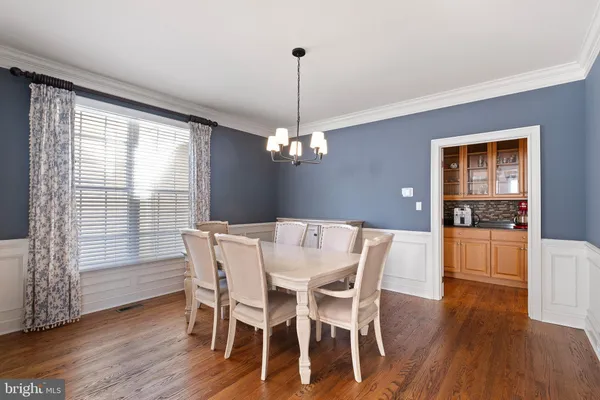 a view of a dining room with furniture window and wooden floor