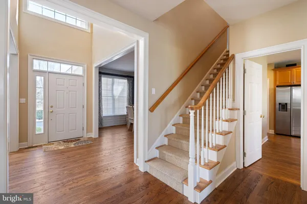 a view of entryway and hall with wooden floor