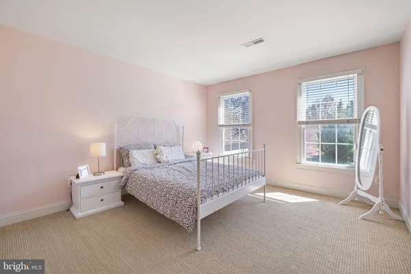 a spacious bedroom with a bed and a window
