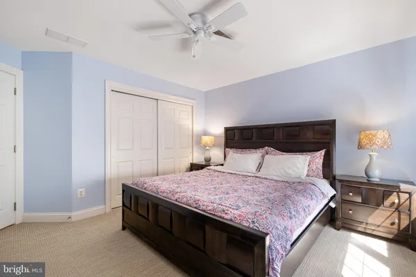 a large bed sitting in a bedroom next to a window