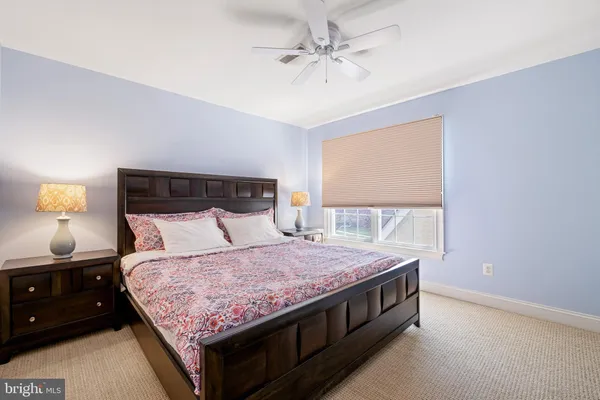 a bedroom with a bed and a night stand
