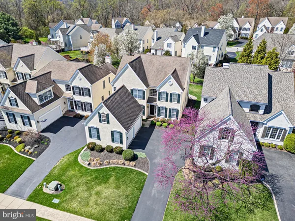 an aerial view of multiple houses with yard