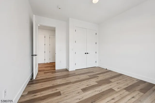 a view of an empty room and wooden floor