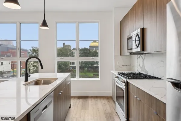a view of kitchen island with stainless steel appliances refrigerator and microwave