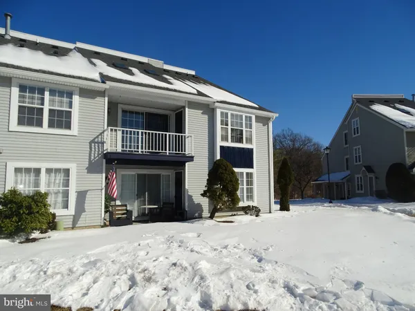 a view of a house with snow in front of house