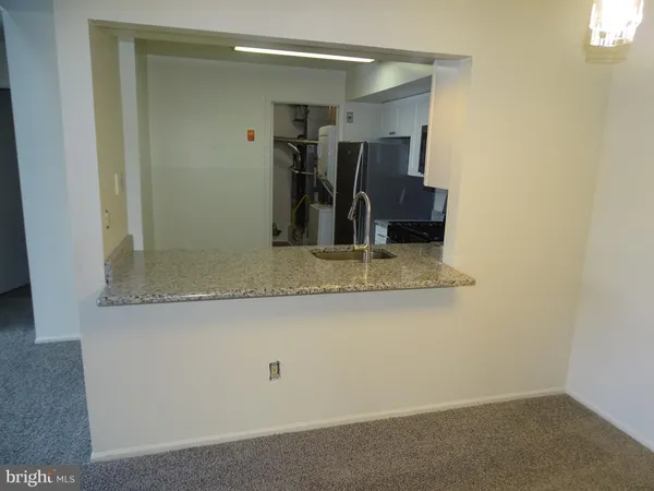 a bathroom with a granite countertop sink a mirror and a shower