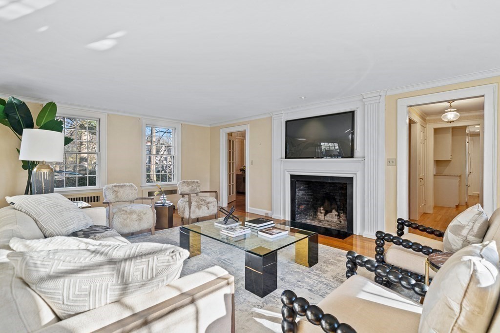 8 Old Farm Road Wellesley, MA 02481 - Photo 11 of 25 a living room with furniture a fireplace and a flat screen tv
