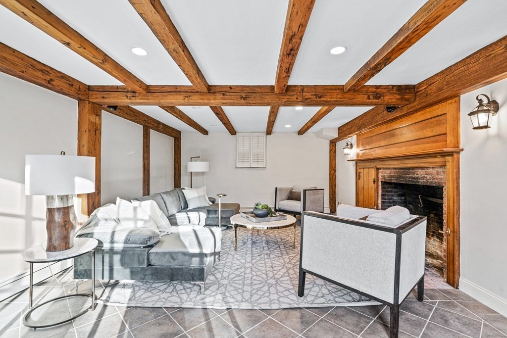 8 Old Farm Road Wellesley, MA 02481 - Photo 21 of 25 a living room with furniture a fireplace and a table