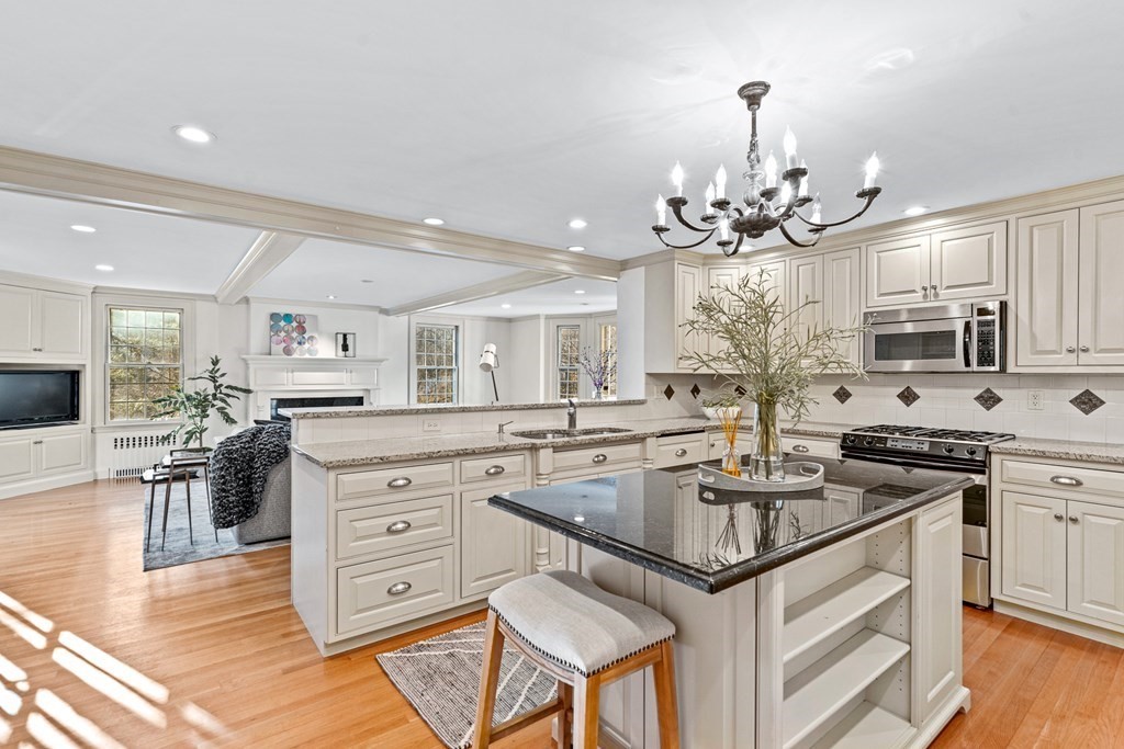 8 Old Farm Road Wellesley, MA 02481 - Photo 6 of 25 a kitchen with stainless steel appliances granite countertop a sink stove and cabinets with wooden floor