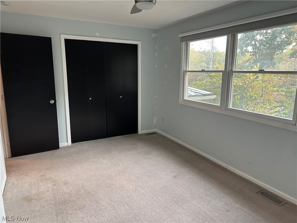 6715 Crosse Road Amherst, OH 44001 - Photo 10 of 21 Unfurnished bedroom with light carpet, ceiling fan, and a closet