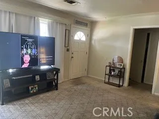 a view of an empty room with window and closet