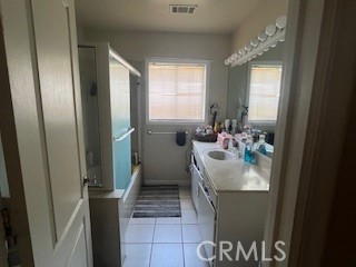 1127 West 23rd Street Merced, CA 95340 - Photo 9 of 14 a bathroom with a sink toilet and shower