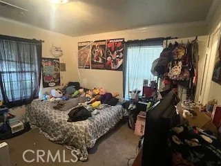 a bed room with a bed a couch and a window