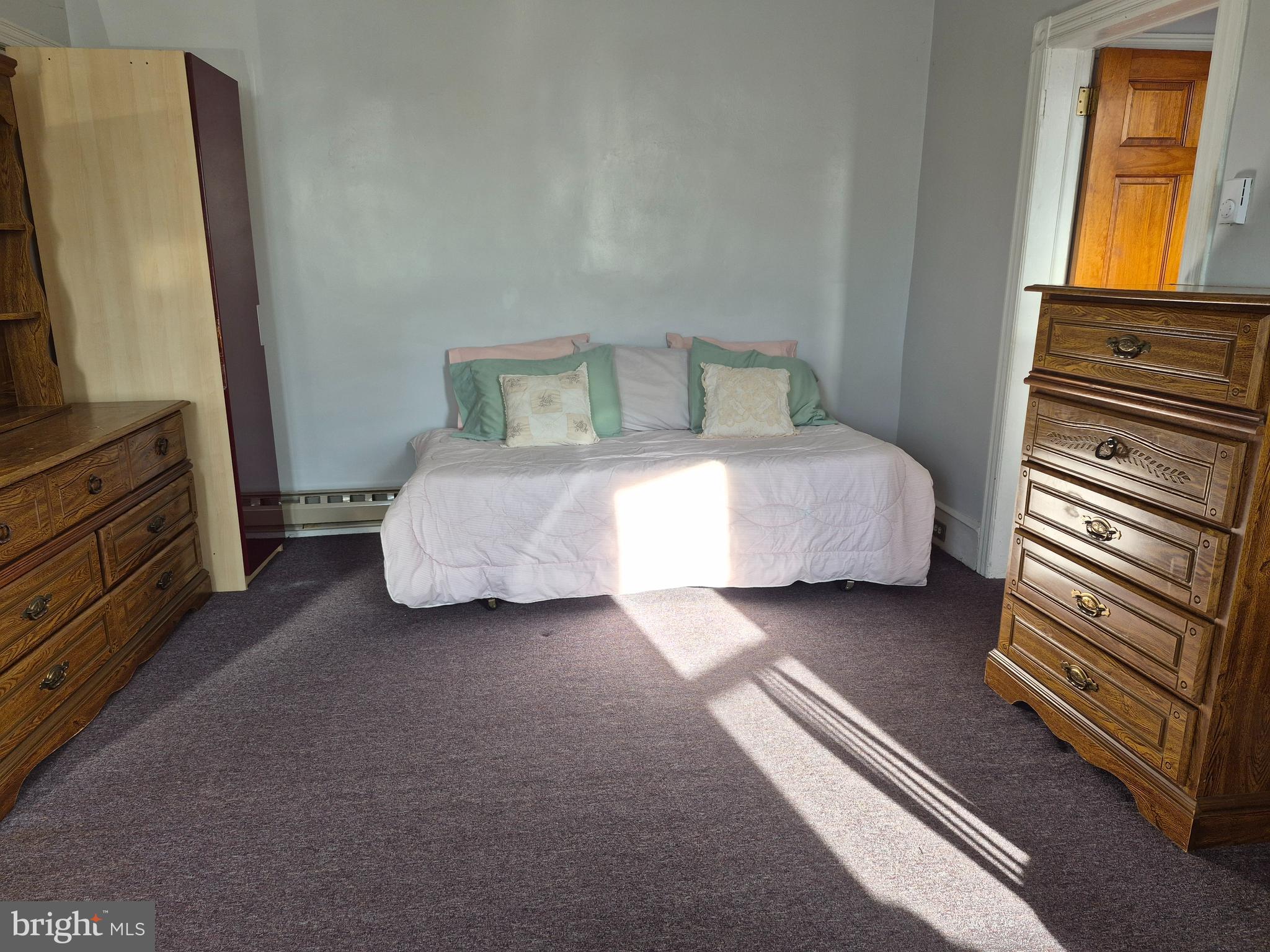 223 Ryers Avenue Cheltenham, PA 19012 - Photo 11 of 25 a bedroom with a bed and a flat tv screen on dresser