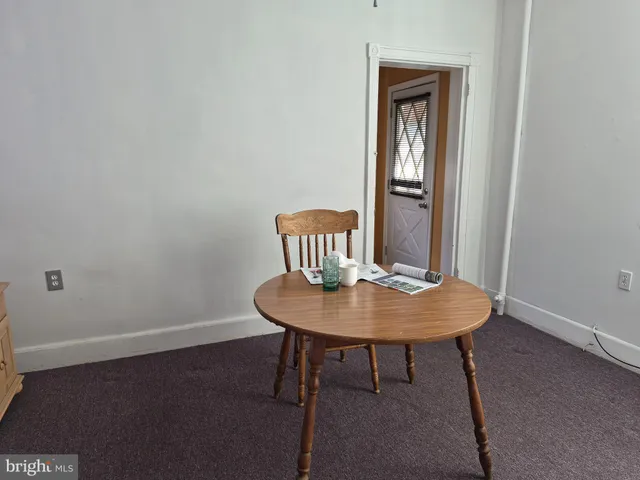 a kitchen with a sink a refrigerator and cabinets