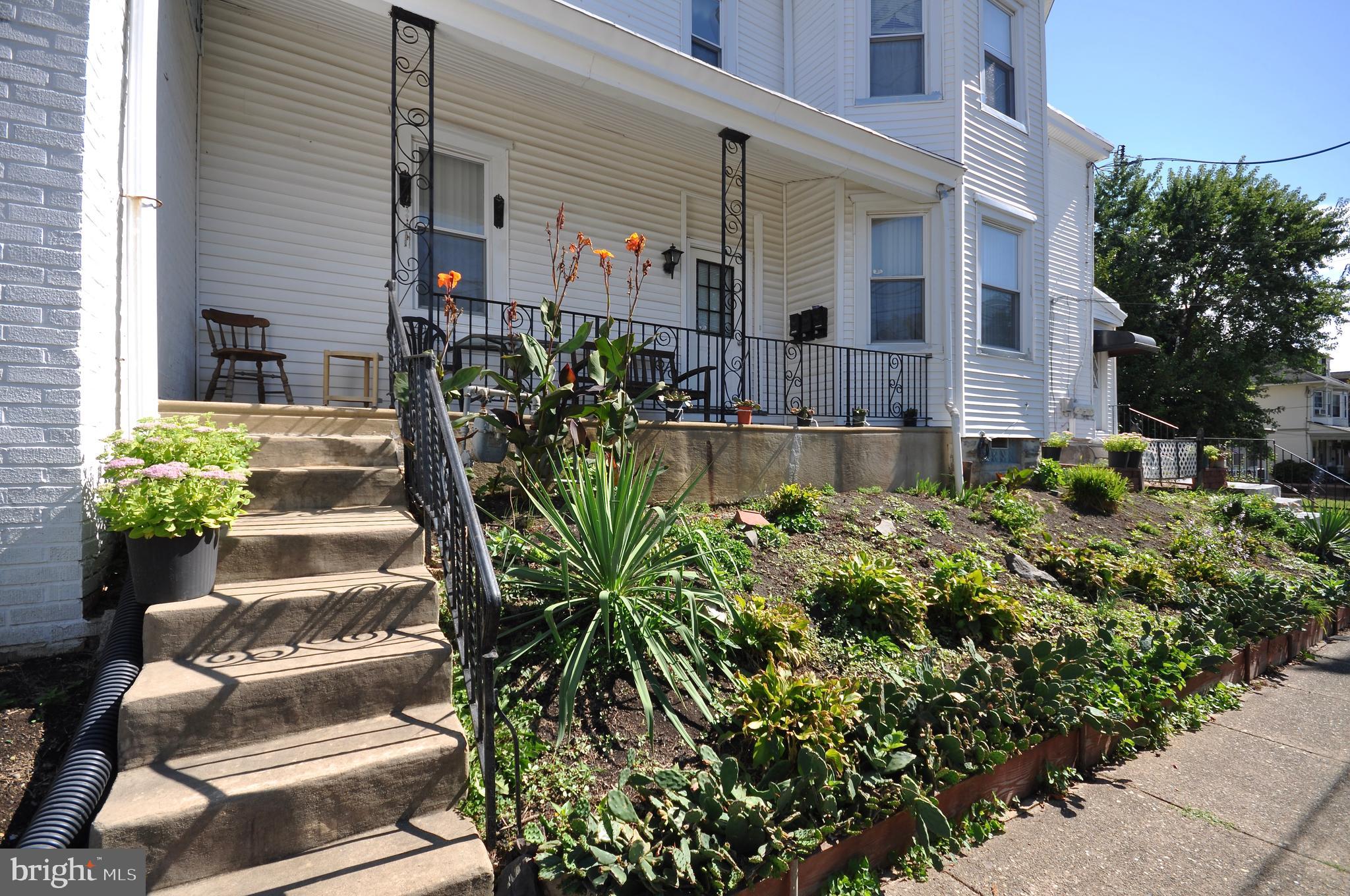 223 Ryers Avenue Cheltenham, PA 19012 - Photo 2 of 25 a view of a house with chairs and flower plants