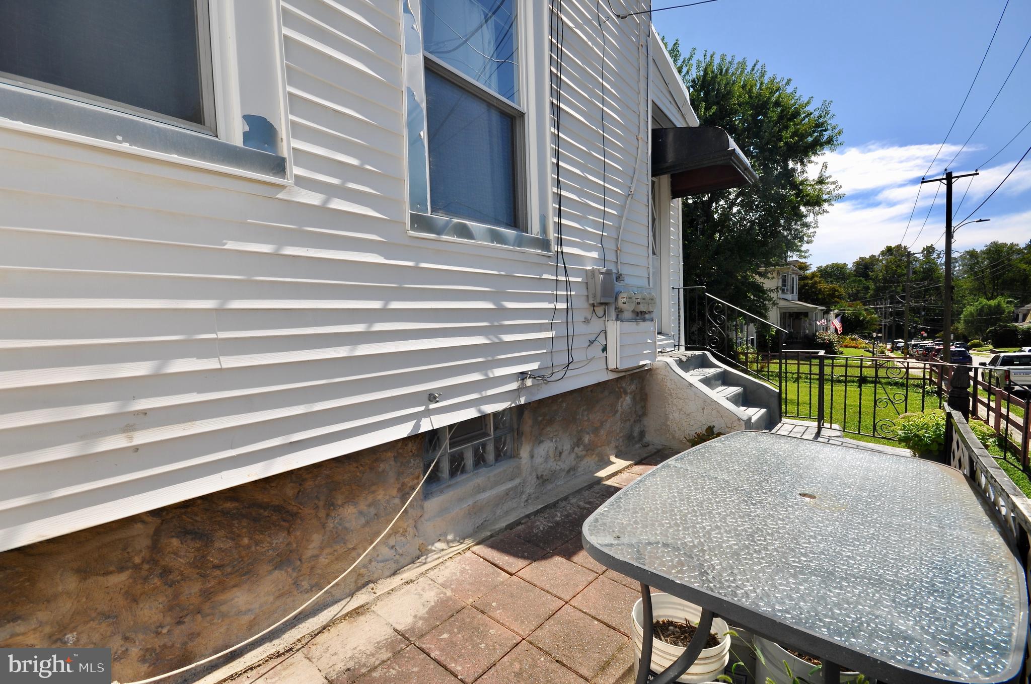 223 Ryers Avenue Cheltenham, PA 19012 - Photo 21 of 25 a view of backyard with two chairs potted plants and floor to ceiling window