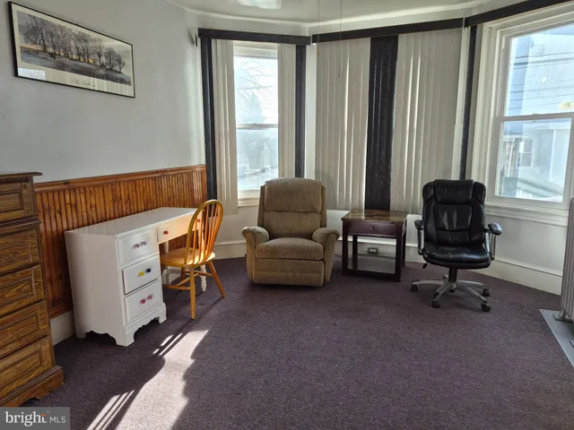 a bedroom with furniture and a window