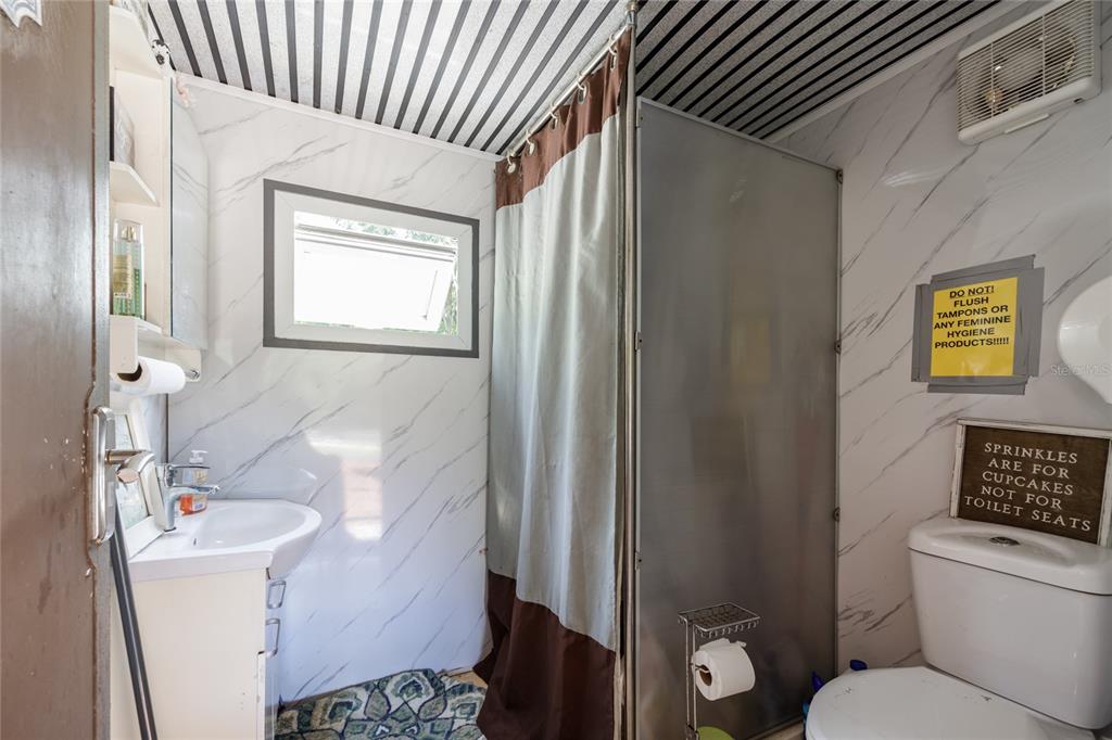 9106 Southwest 124 Street Archer, FL 32618 - Photo 11 of 57 a bathroom with a sink toilet and shower