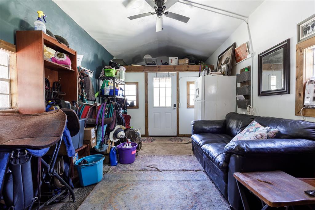 9106 Southwest 124 Street Archer, FL 32618 - Photo 14 of 57 a living room with furniture a ceiling fan and a window