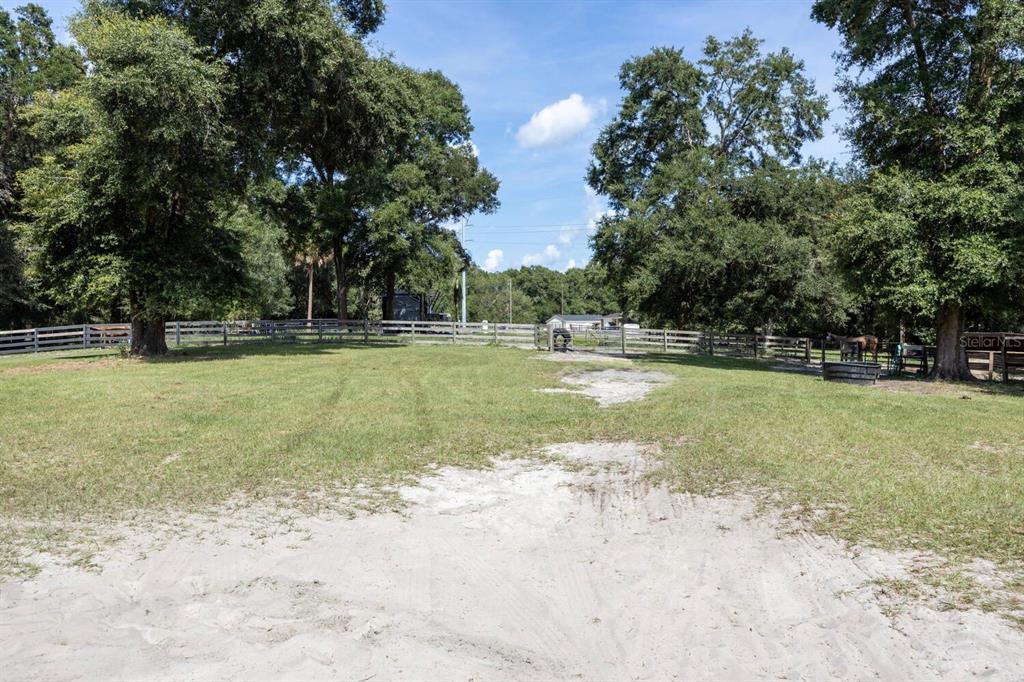 9106 Southwest 124 Street Archer, FL 32618 - Photo 20 of 57 a view of a swimming pool with an outdoor space and seating area