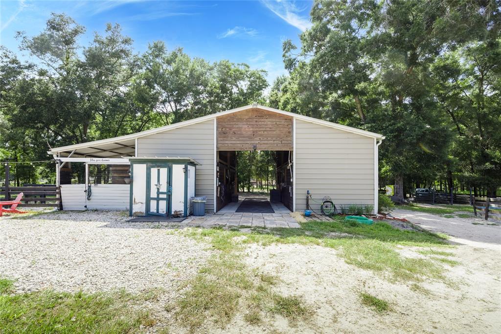 9106 Southwest 124 Street Archer, FL 32618 - Photo 8 of 57 a front view of a house with a yard and garage