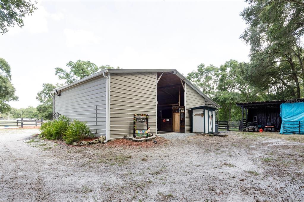 9106 Southwest 124 Street Archer, FL 32618 - Photo 9 of 57 a view of a house with a patio and a yard