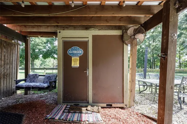 a view of a house with backyard porch and sitting area