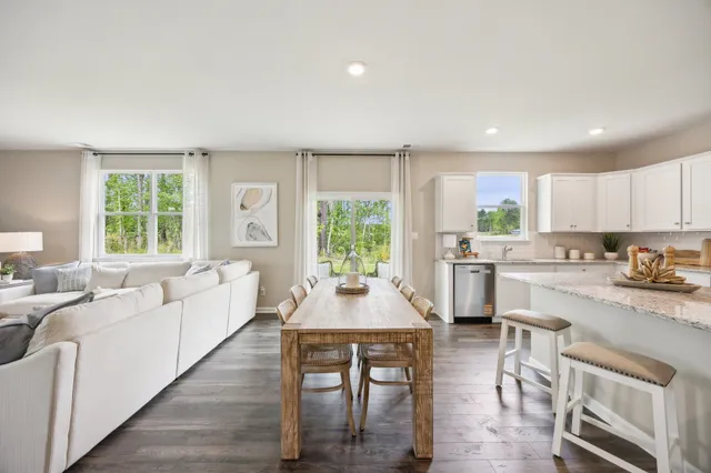 a kitchen with a table chairs stove and cabinets