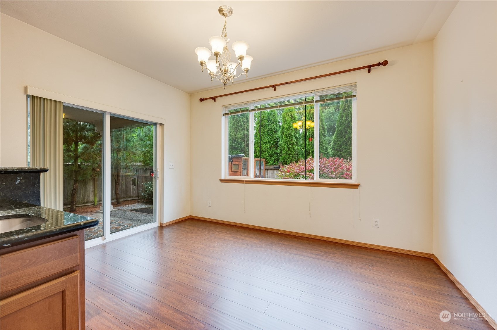 1321 173 Place Southeast Bothell, WA 98012 - Photo 11 of 25 a view of a livingroom with wooden floor fireplace and windows