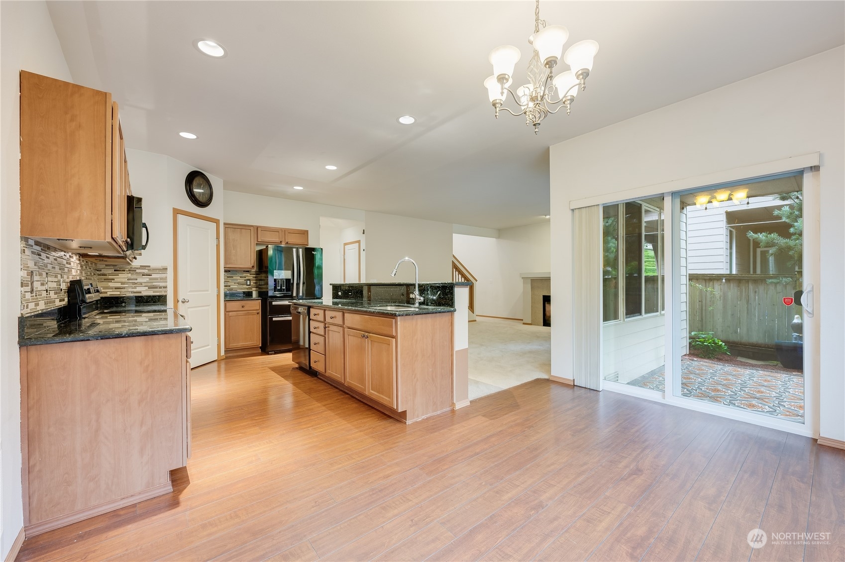 1321 173 Place Southeast Bothell, WA 98012 - Photo 12 of 25 a large kitchen with kitchen island a stove a refrigerator a sink dishwasher with a dining table and chairs
