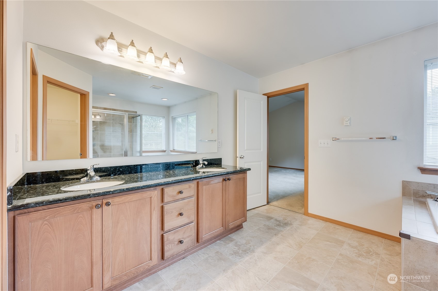 1321 173 Place Southeast Bothell, WA 98012 - Photo 16 of 25 a large bathroom with a granite countertop sink and a mirror