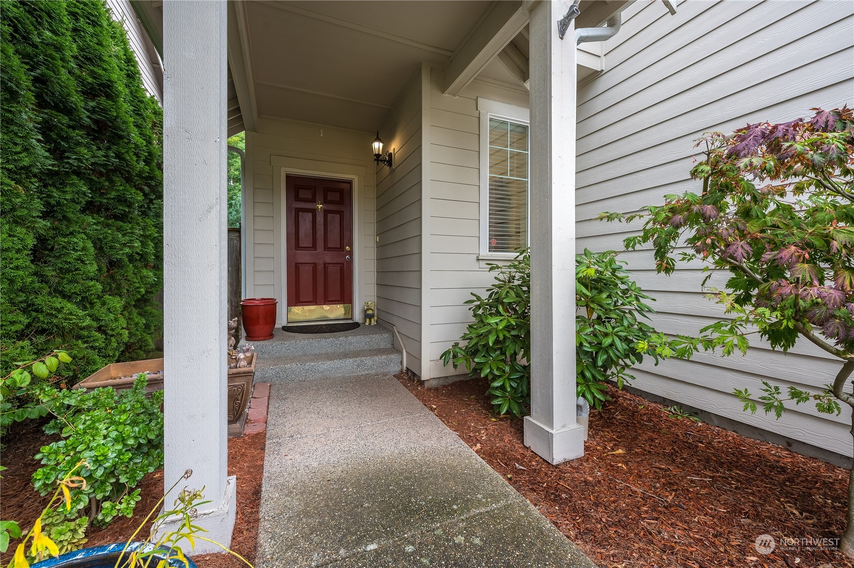 1321 173 Place Southeast Bothell, WA 98012 - Photo 2 of 25 a view of yellow house with flower plants