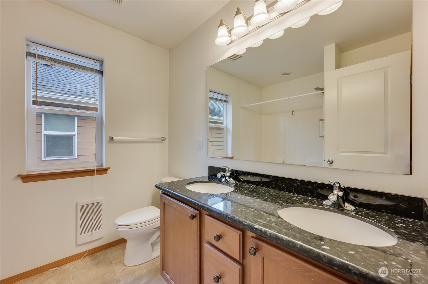 1321 173 Place Southeast Bothell, WA 98012 - Photo 21 of 25 a bathroom with a granite countertop double vanity sink and a mirror