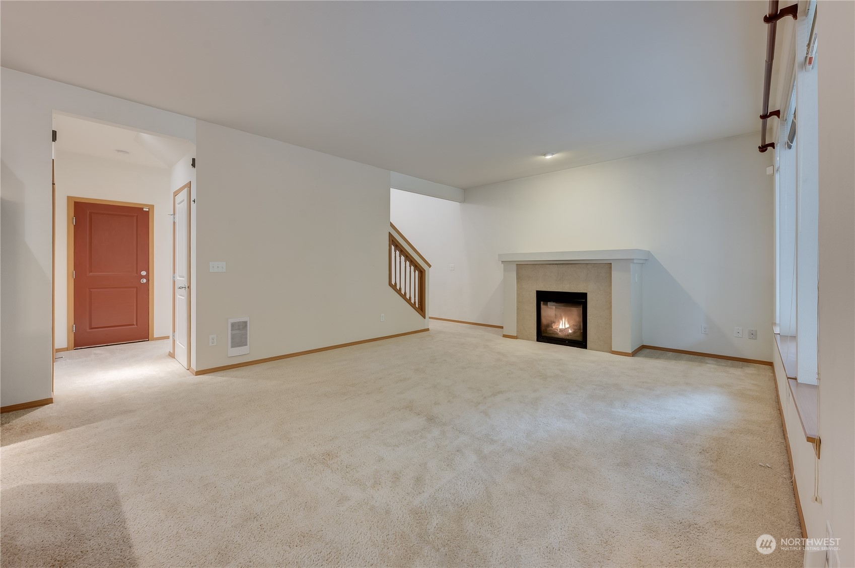 1321 173 Place Southeast Bothell, WA 98012 - Photo 6 of 25 a view of an empty room with a fireplace and a window
