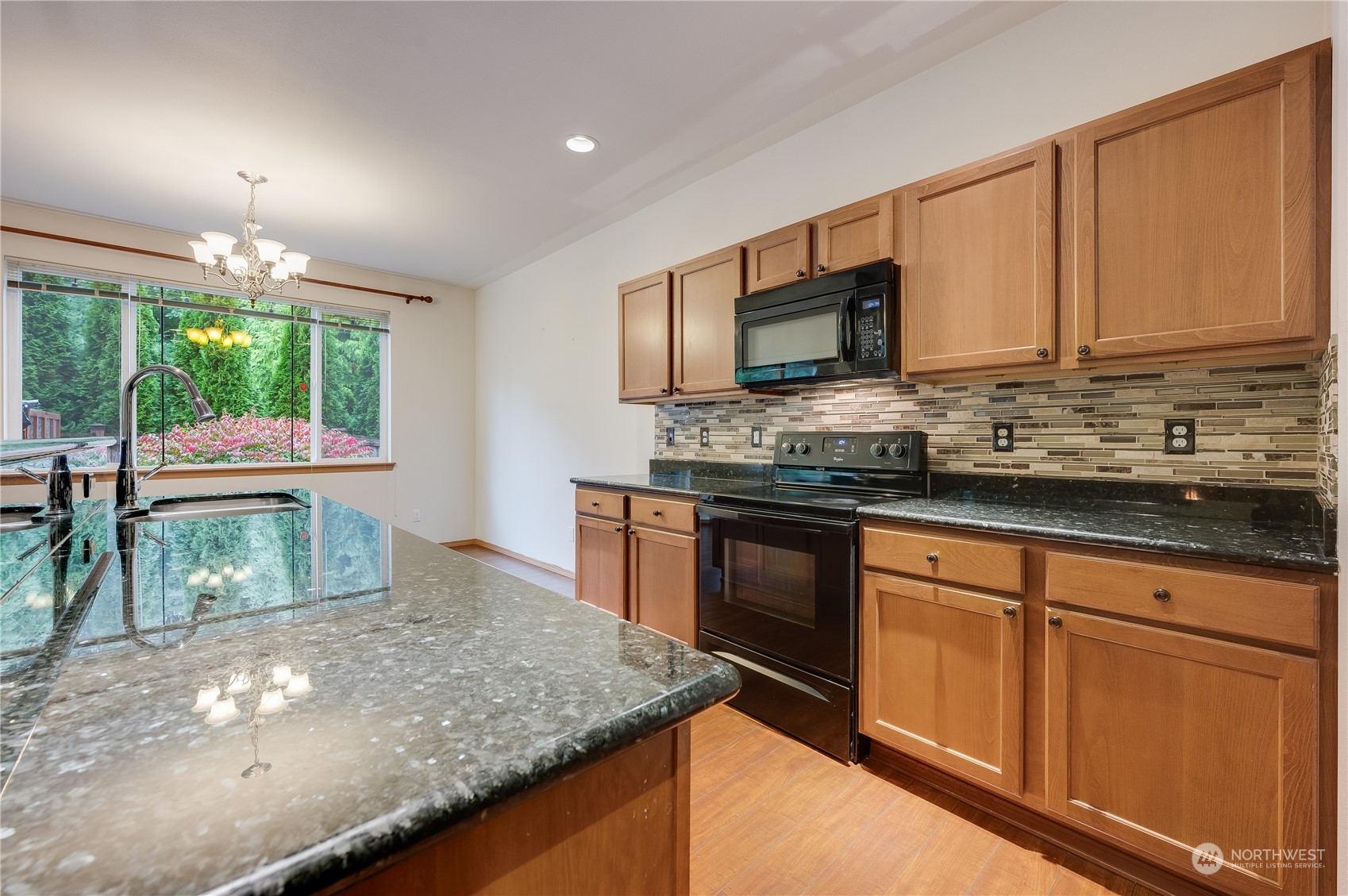1321 173 Place Southeast Bothell, WA 98012 - Photo 7 of 25 a kitchen with stainless steel appliances granite countertop a sink and a stove