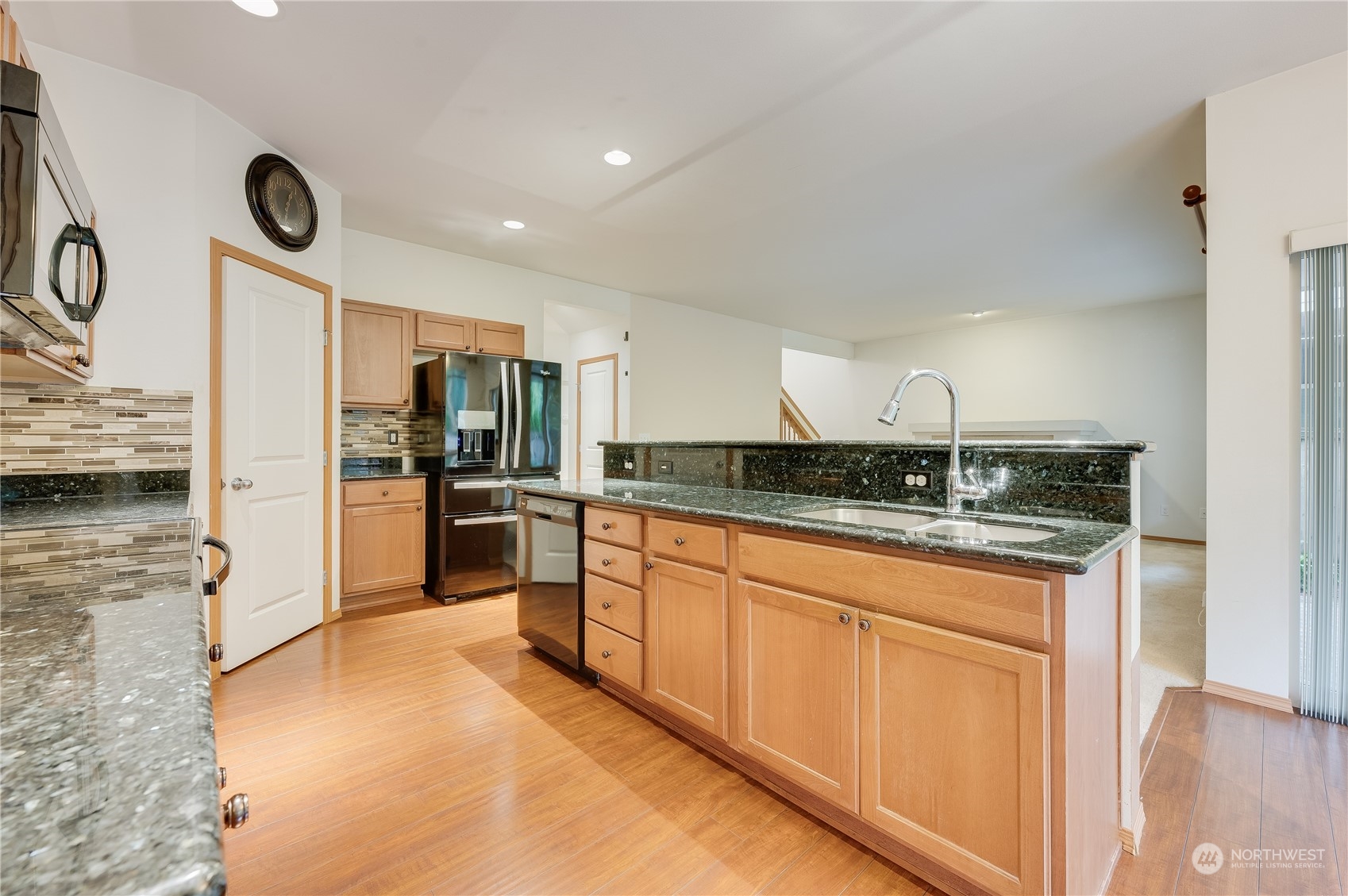 1321 173 Place Southeast Bothell, WA 98012 - Photo 8 of 25 a kitchen with stainless steel appliances granite countertop a stove a sink and a refrigerator