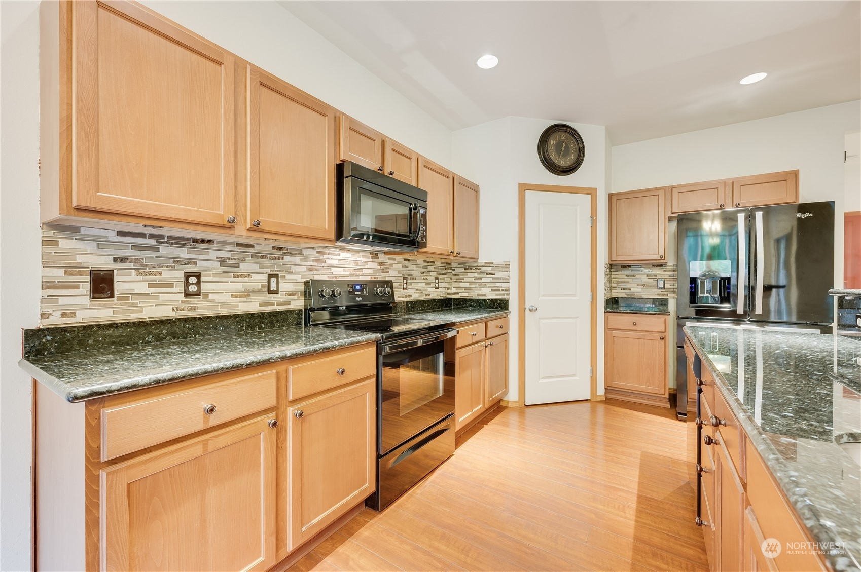 1321 173 Place Southeast Bothell, WA 98012 - Photo 9 of 25 a kitchen with stainless steel appliances granite countertop a stove sink and cabinets