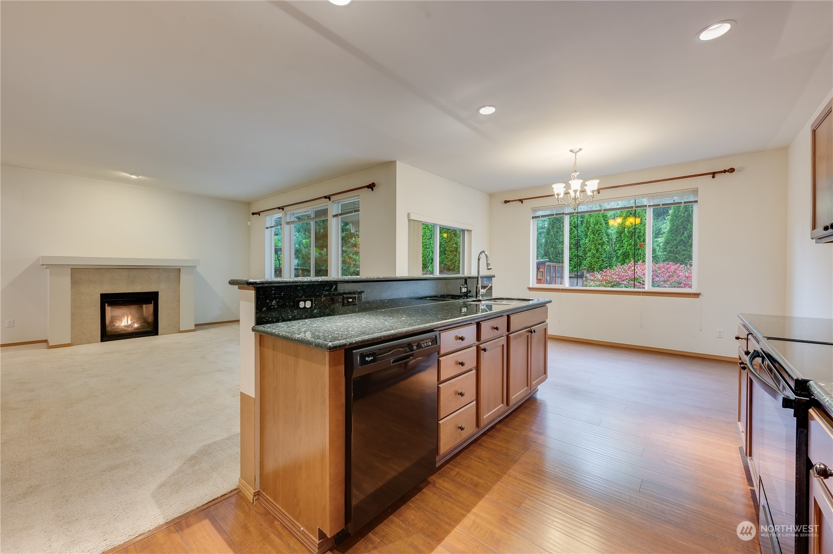 1321 173 Place Southeast Bothell, WA 98012 - Photo 10 of 25 a kitchen with kitchen island granite countertop a stove and a sink