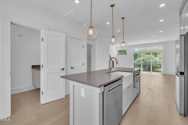 a kitchen with granite countertop a sink cabinets and window