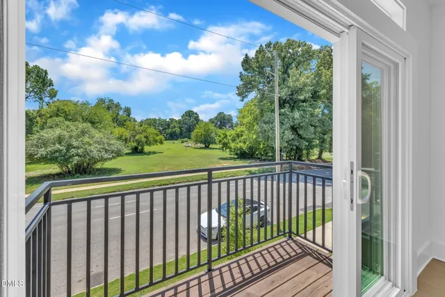 a view of a balcony with wooden fence