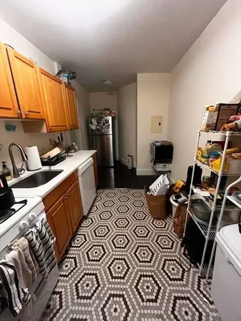 a kitchen with a sink appliances and cabinets